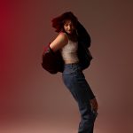 portrait of woman standing on tiptoes doing a dance