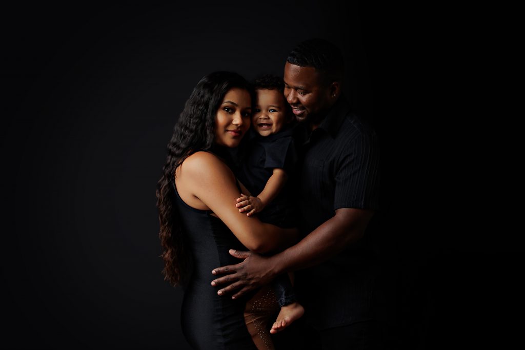 maternity photo of pregnant african american woman with her son and spouse