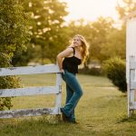 senior portrait photography white wooden fence sunset golden hour black top jeans gilford new hampshire