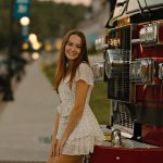senior portrait photography city lights short white dress walking in street bokeh gilford laconia new hampshire sunset golden hour fire truck