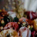 a wedding ring surrounded by flowers