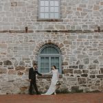 a couple in wedding attire holding hands