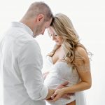 maternity photo of pregnant woman with the spouse holding her stomach