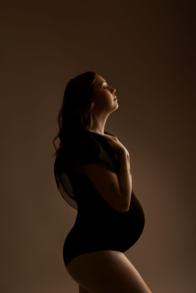 maternity photography studio concord new hampshire see through dress tan solid backdrop red hair backlit silhouette