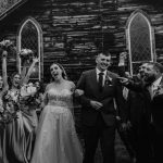 wedding photography bishop farm weddings and events new hampshire wedding venue black and white bride and groom walking through bridal party