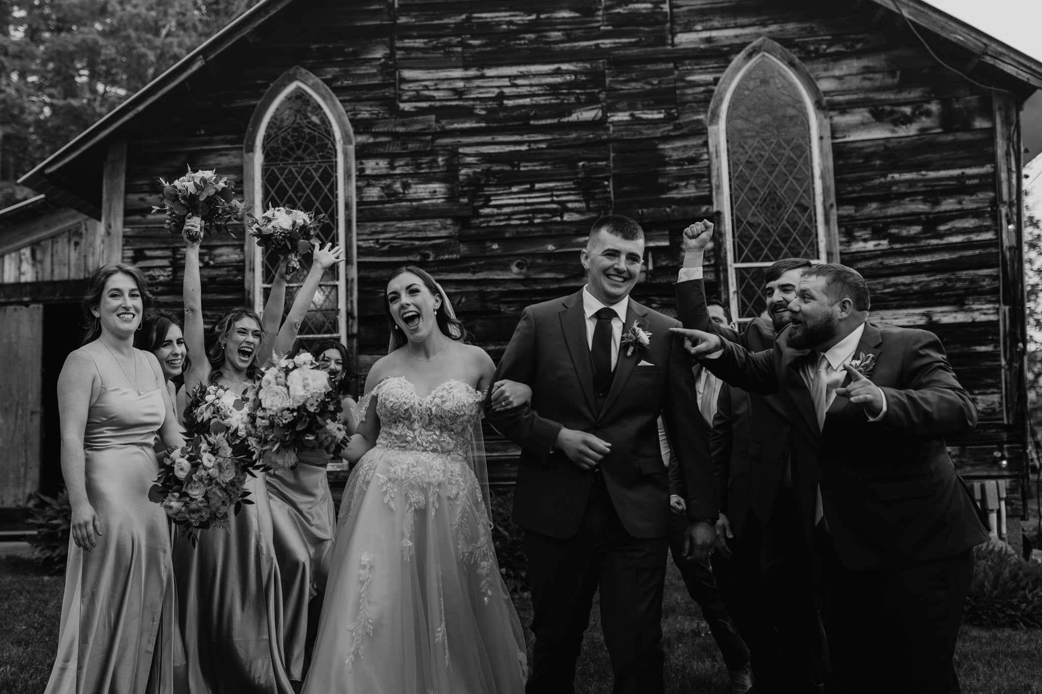 wedding photography bishop farm weddings and events new hampshire wedding venue black and white bride and groom walking through bridal party