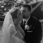 wedding photography black and white groom kissing bride with veil new hampshire