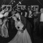 wedding photography bishop farms weddings and events new hampshire bride and groom walking through sparkler sendoff red barn black and white