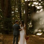 wedding photography alvirne memorial chapel derry new hampshire bride and groom locked arms looking at eachother