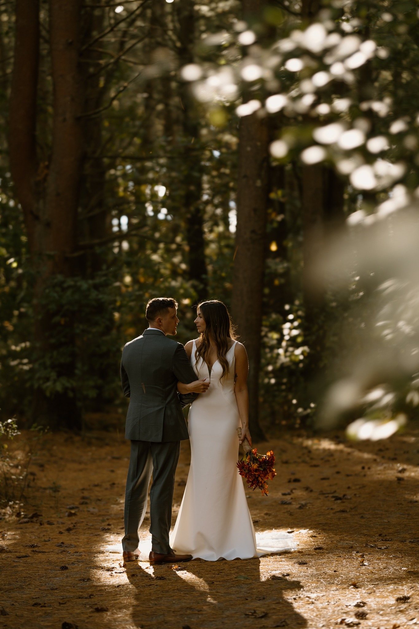 wedding photography alvirne memorial chapel derry new hampshire bride and groom locked arms looking at eachother