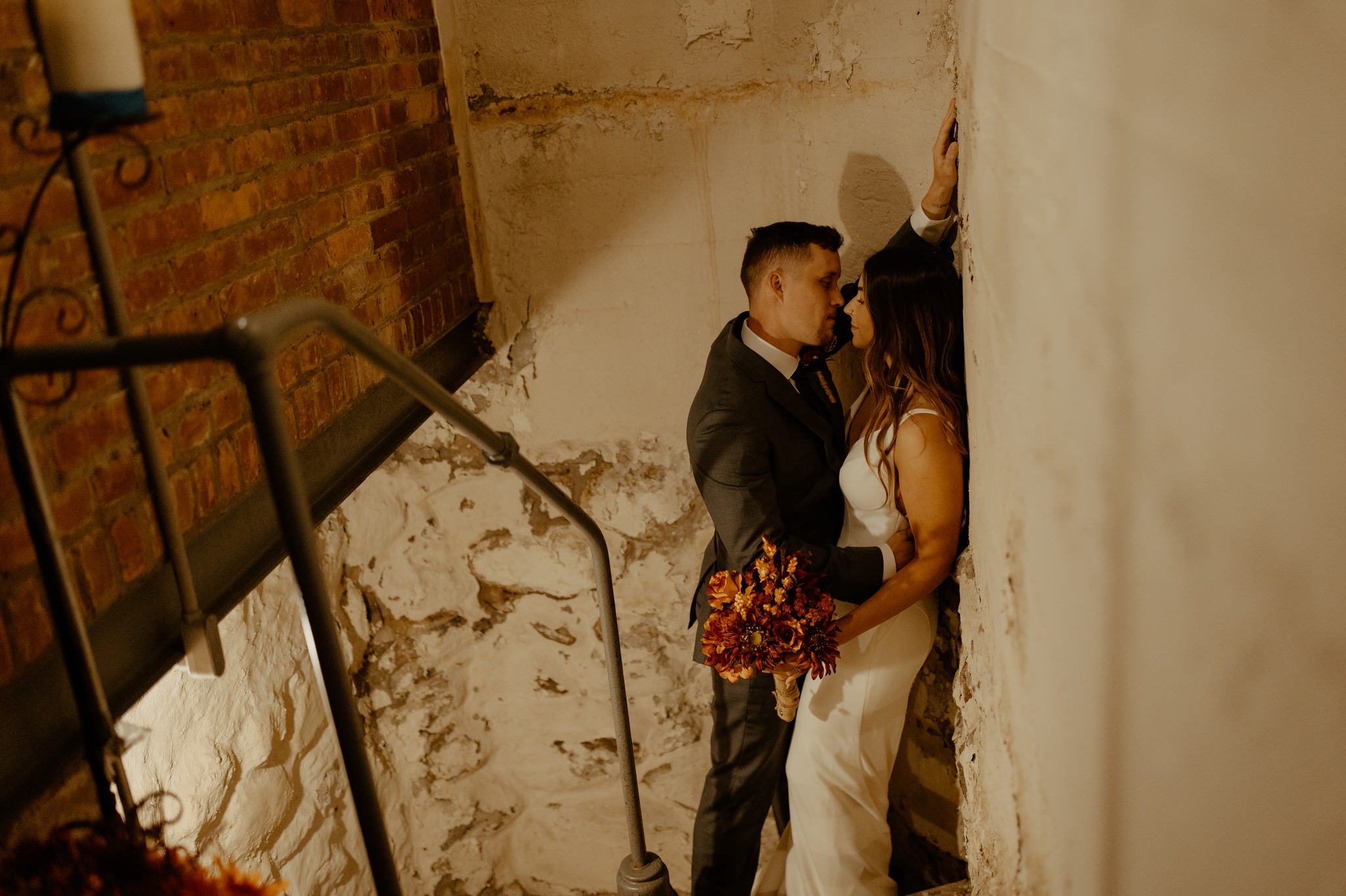 wedding photography bride and groom alvirne memorial chapel new hampshire kissing stairwell bouquet
