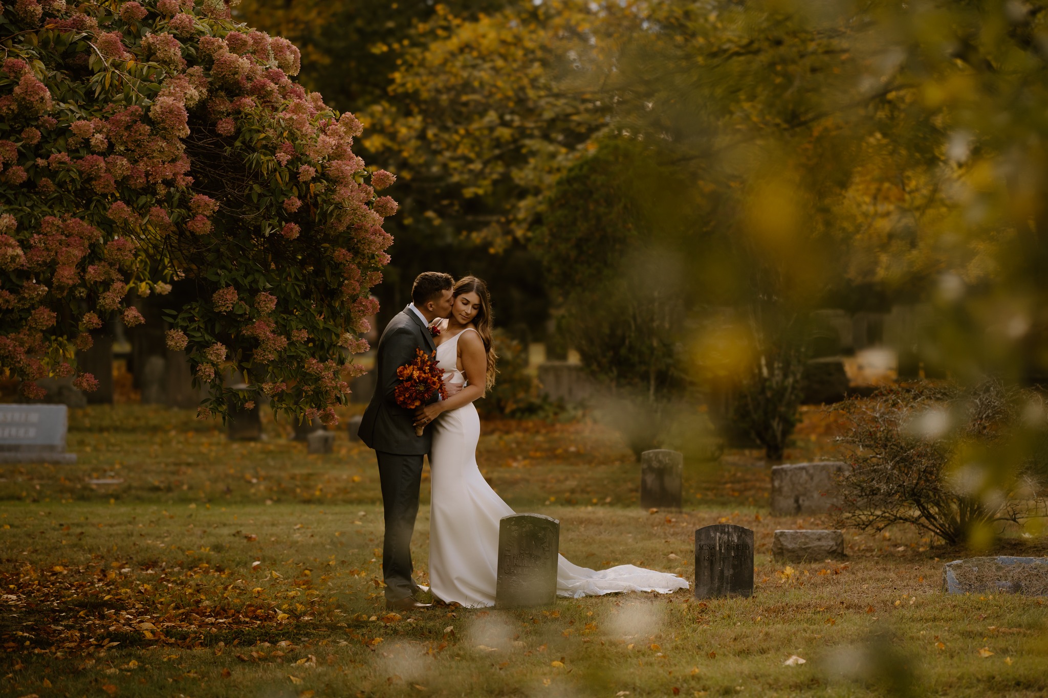 wedding photography alvirne memorial chapel derry new hampshire bride and groom kissing tomb stones cemetery