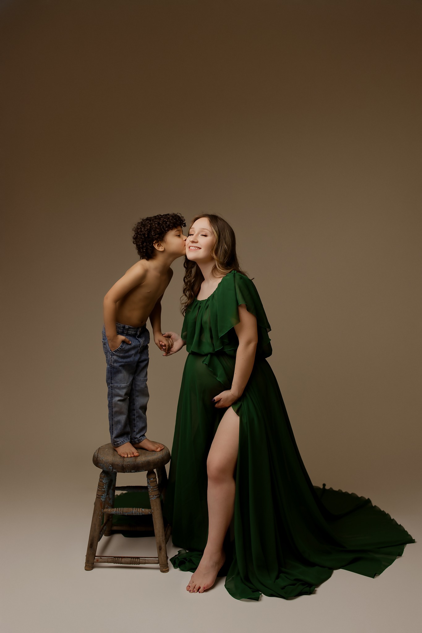 maternity photography mom holding son kissing holding belly green dress golden hour concord new hampshire studio