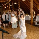 wedding photography pike's peek wedding venue new hampshire bride tossing bouquet to women at wedding reception