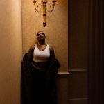 portrait photography woman standing against wallpaper chandelier hotel studio lights concord new hampshire