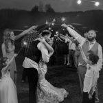 wedding photography bride and groom kissing under sparkler sendoff pikes peek new hampshire wedding venue black and white