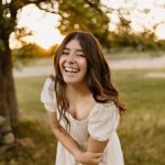 senior portrait photography white wooden fence sunset golden hour black top jeans gilford new hampshire