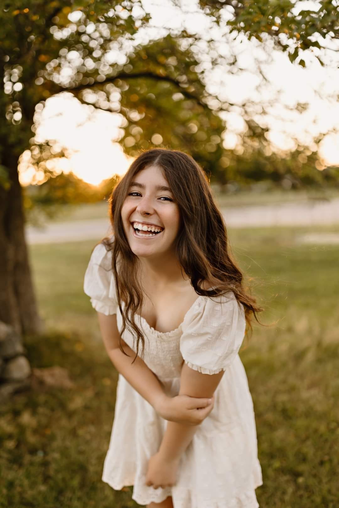 senior portrait photography white wooden fence sunset golden hour black top jeans gilford new hampshire