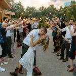 wedding photography barn and bull meadow concord new hampshire wedding venue bride and groom kissing under sparker sendoff 4th of july independence day wedding