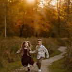 family photography brother and sister running holding hands outdoors trail park concord new hampshire sunset golden hour