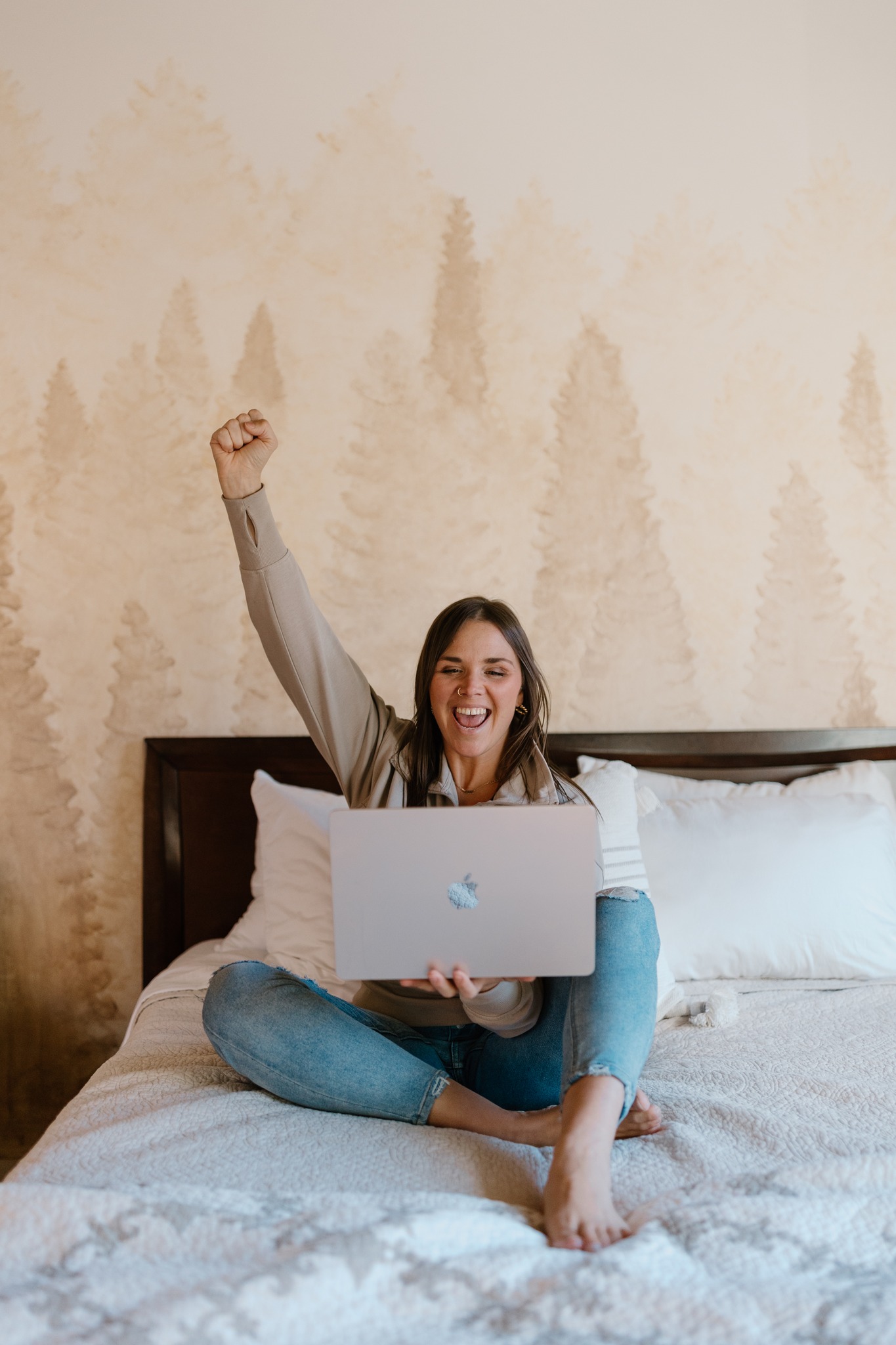 branding photography laptop woman on bed fist in air celebrating branding photography concord new hampshire