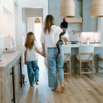 portrait family photography holding hands in home lifestyle holding baby mom sister siblings daughters concord new hampshire