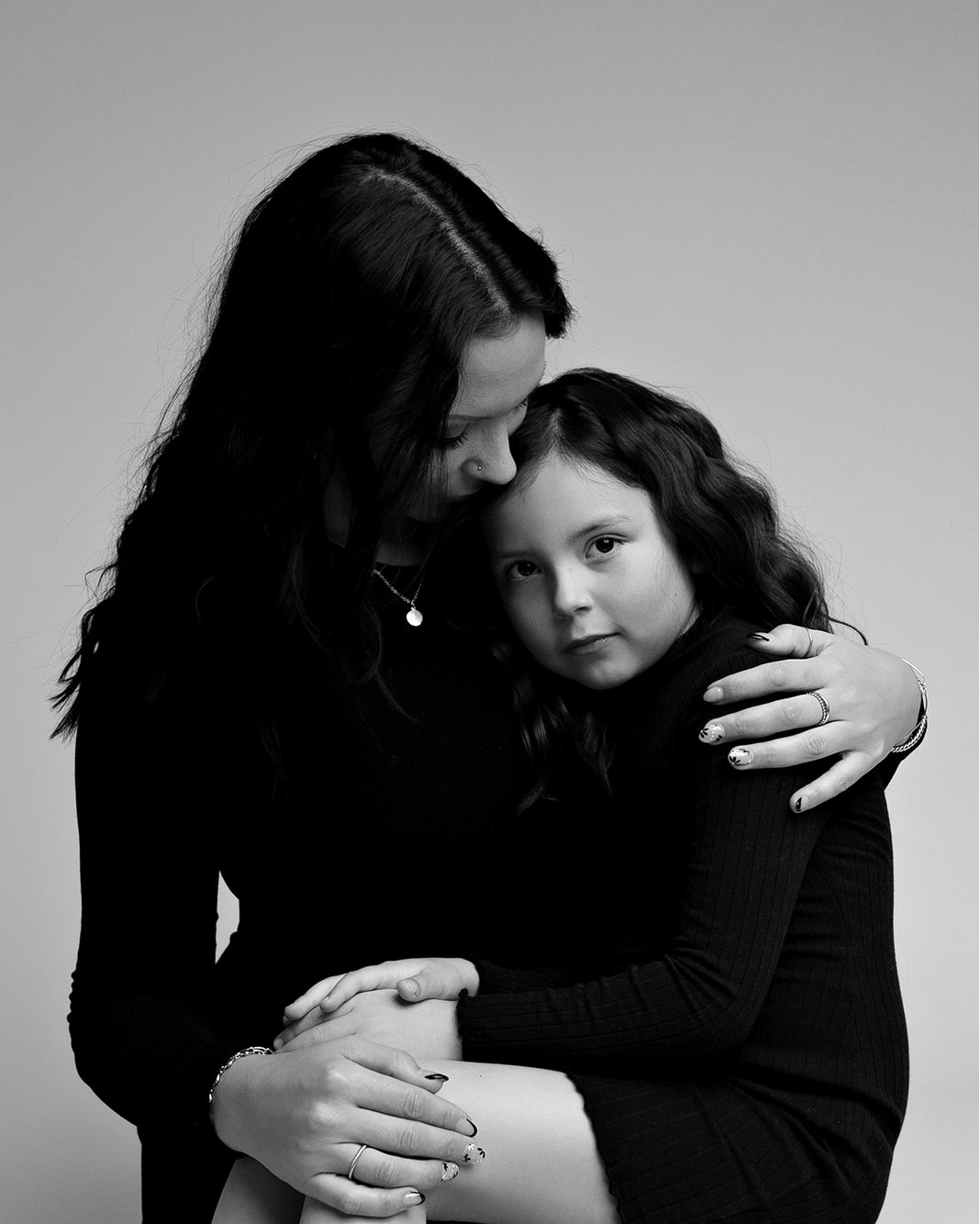 family portrait photography black and white mom and daughter hugging holding each other concord new hampshire studio