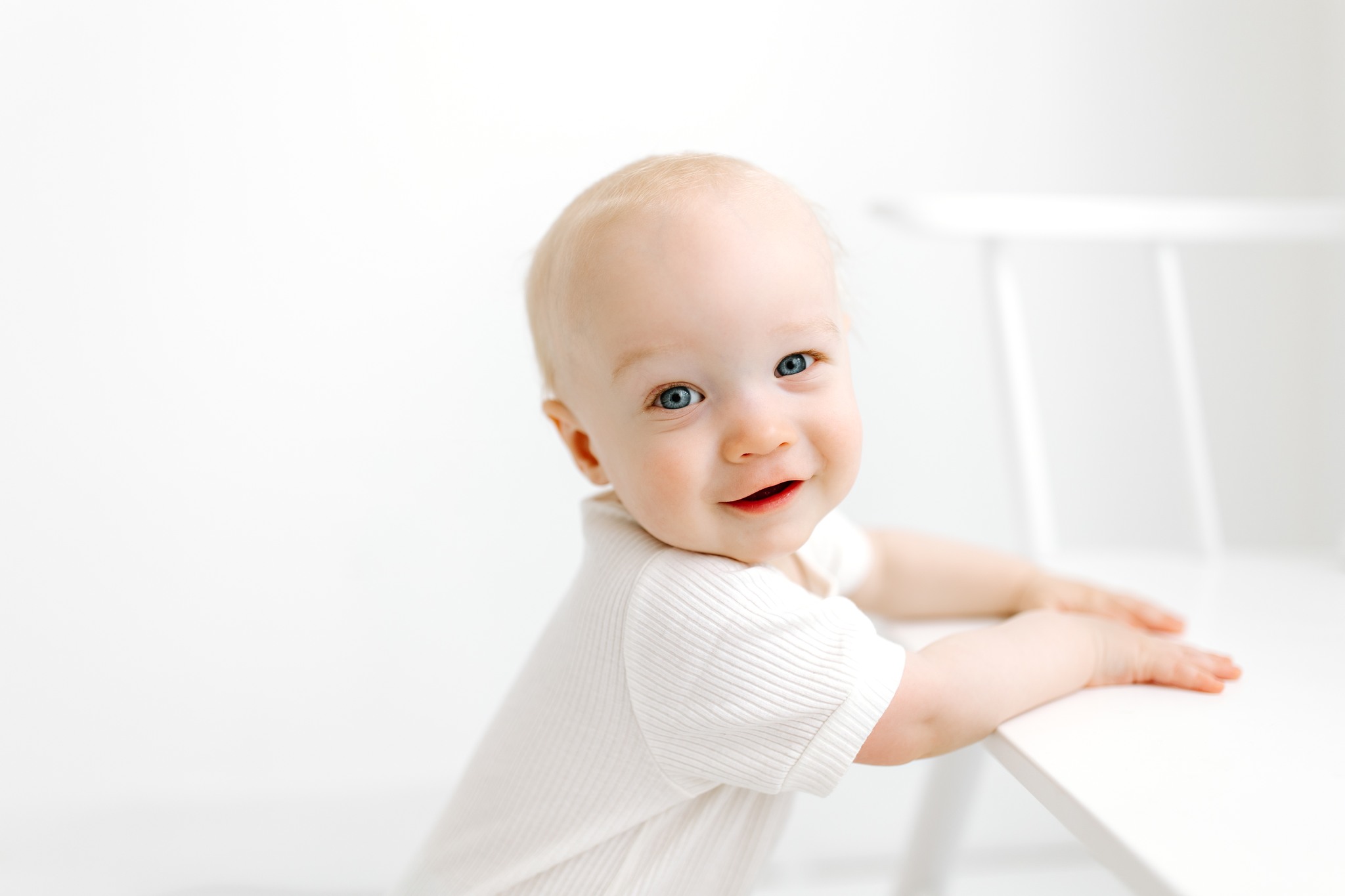 childhood milestone photography portrait white backdrop natural light white shirt bench standing concord new hampshire studio