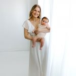 family portrait photography mom holding baby white dress white backdrop curtains concord new hampshire studio lifestyle