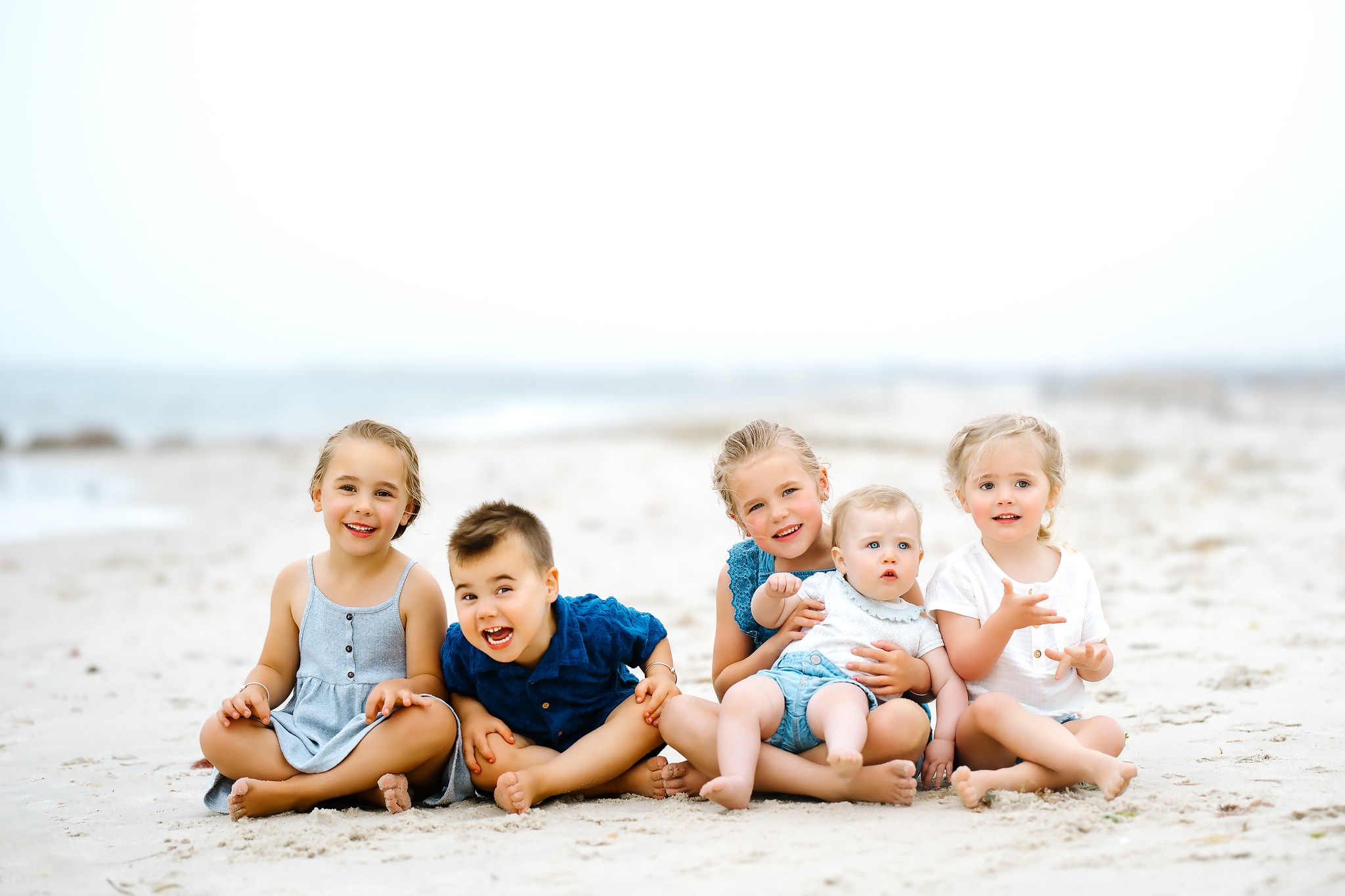 portrait photography family kids childhood beach sand ocean sunset golden hour running holding hands blue dress shirt brother sister boy girl concord new hampshire cousins sisters
