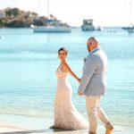 wedding photography new hampshire virgin islands water island weddings Caribbean ocean beach wedding white sand bride and groom holding hands walking down beach