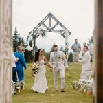 wedding photography bride and groom walking down isle holding hands bouquet coleman state park new hampshire wedding venue