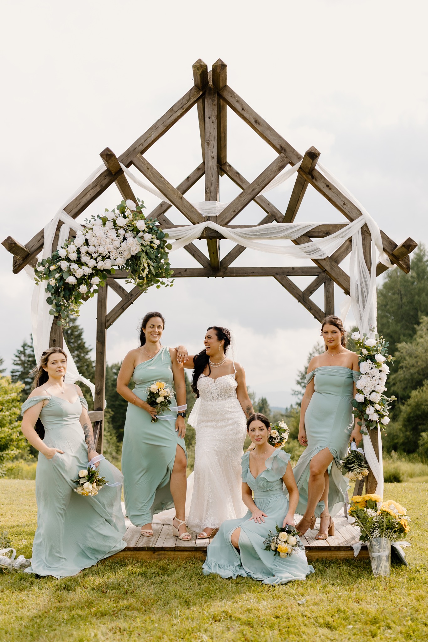 wedding photography coleman state park bride and bridesmaids posing under arbor new hampshire