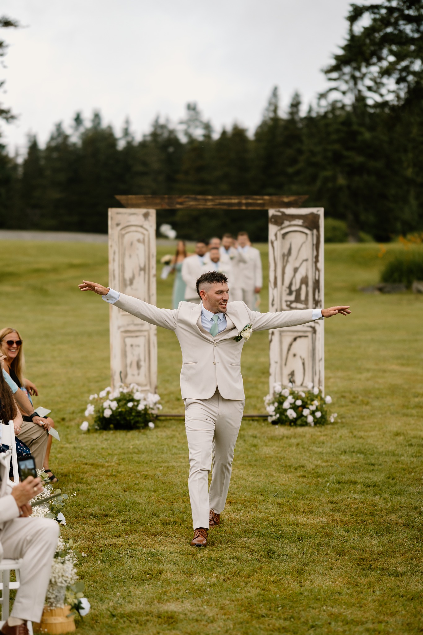 wedding photography bride and groom walking down isle holding hands bouquet coleman state park new hampshire wedding venue