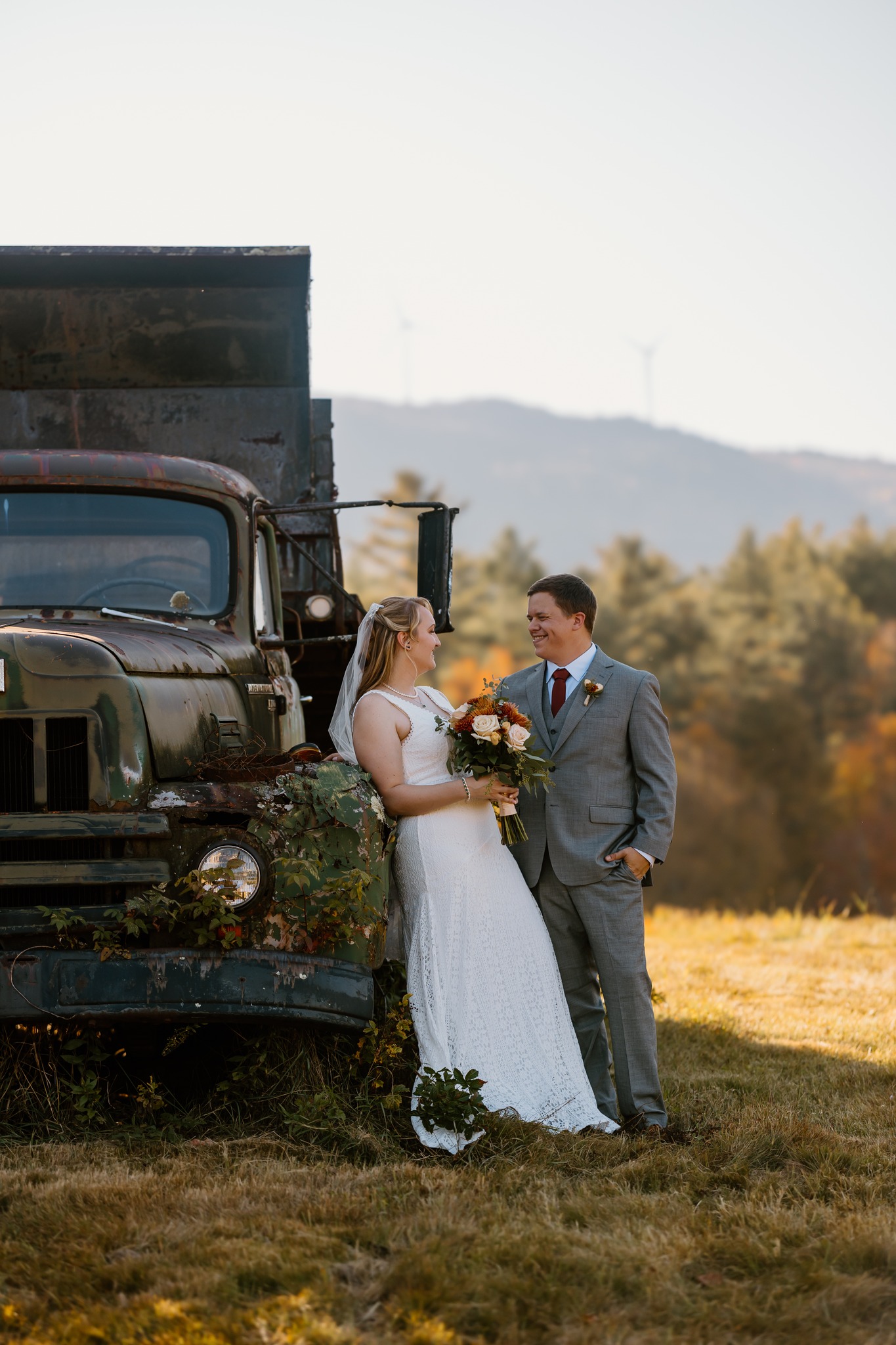 wedding photography black and white bride and groom windmills holding hands old truck yeaton family farm new hampshire flowers sunset golden hour
