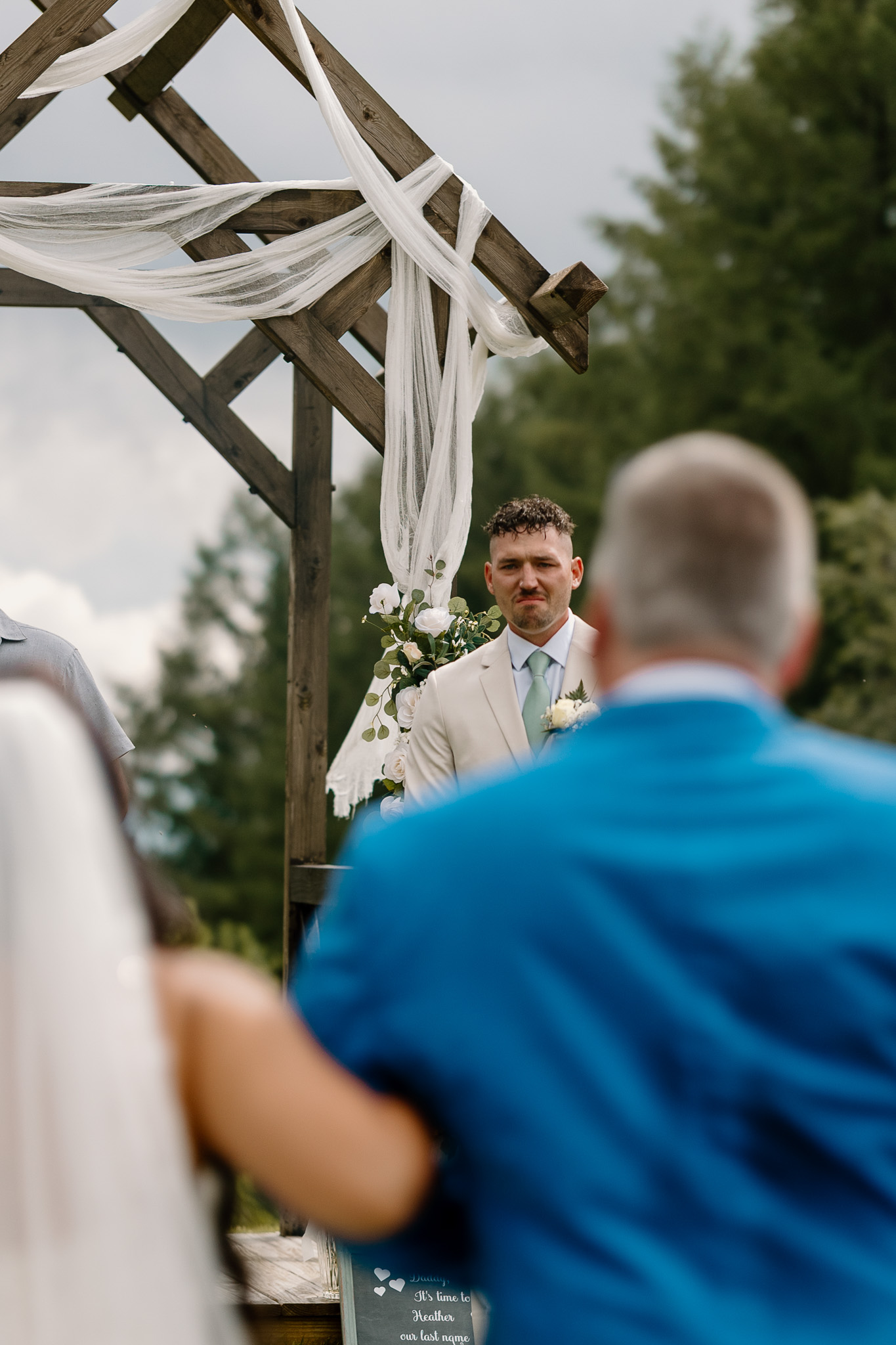 wedding portrait where you can see the emotional groom between the bride and father of the bride walking down the isle, nh