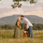 Maternity portrait with couple and golden retriever dog with mountains in background, NH