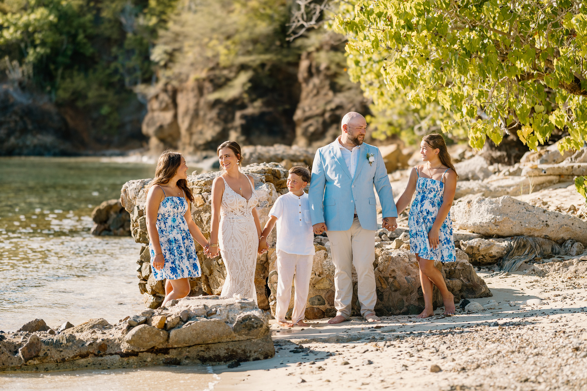 Bride and groom exchange vows during a beach wedding ceremony on Water Island, St. Thomas, USVI, surrounded by tropical ocean views.