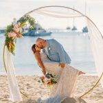 Bride and groom exchange vows during a beach wedding ceremony on Water Island, St. Thomas, USVI, surrounded by tropical ocean views.