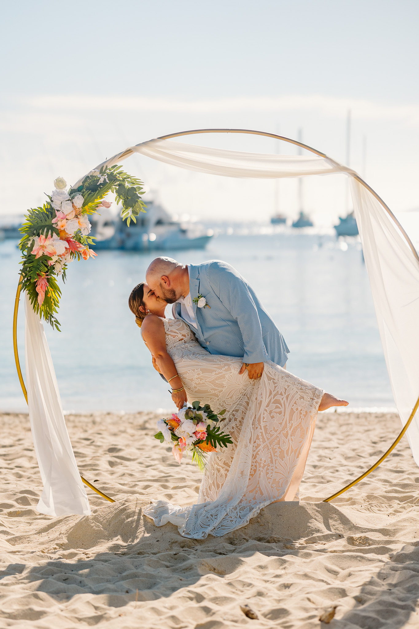 Bride and groom exchange vows during a beach wedding ceremony on Water Island, St. Thomas, USVI, surrounded by tropical ocean views.