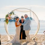 Bride and groom exchange vows during a beach wedding ceremony on Water Island, St. Thomas, USVI, surrounded by tropical ocean views.