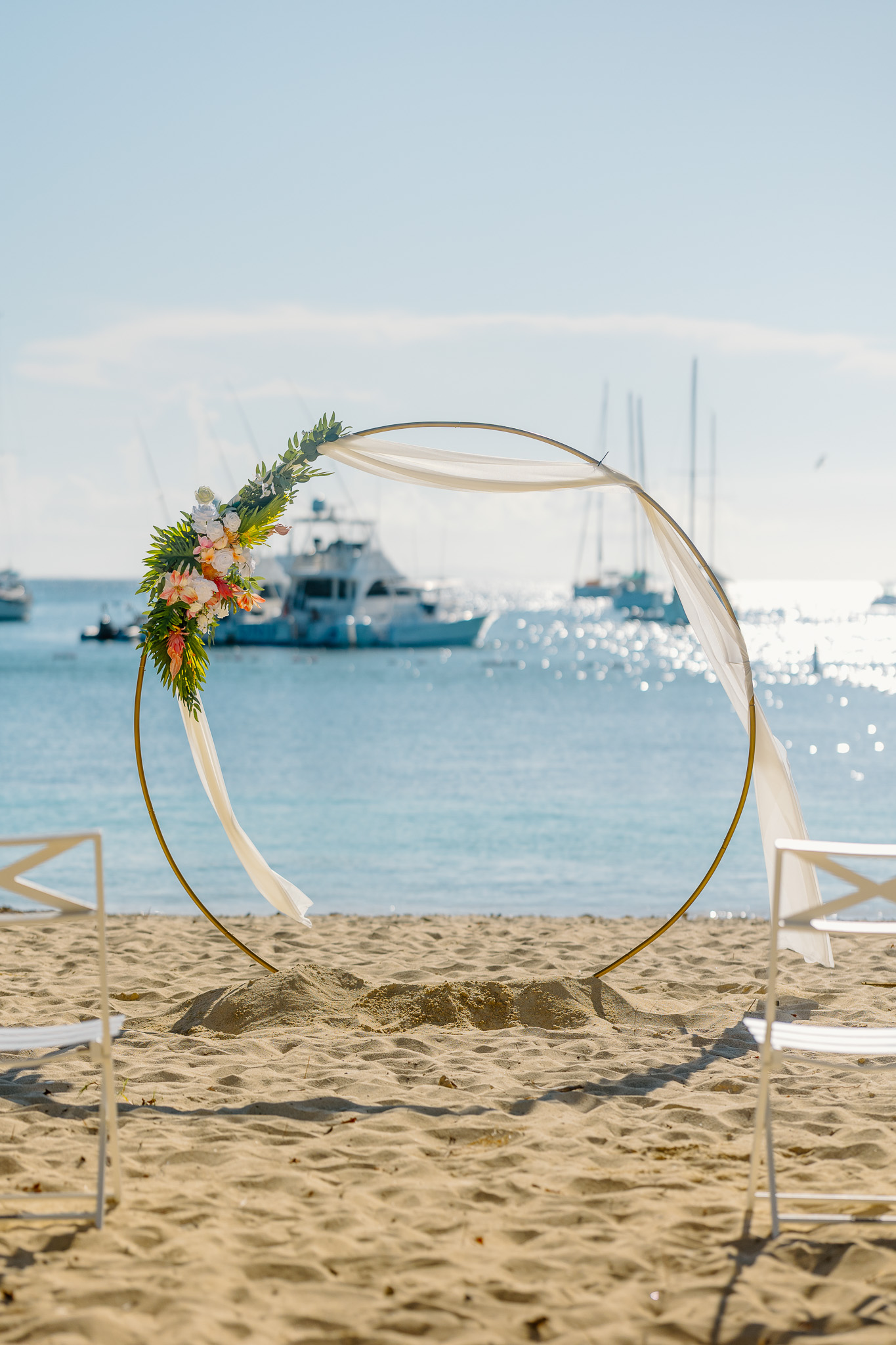 Bride and groom exchange vows during a beach wedding ceremony on Water Island, St. Thomas, USVI, surrounded by tropical ocean views.