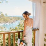 Bride and groom exchange vows during a beach wedding ceremony on Water Island, St. Thomas, USVI, surrounded by tropical ocean views.