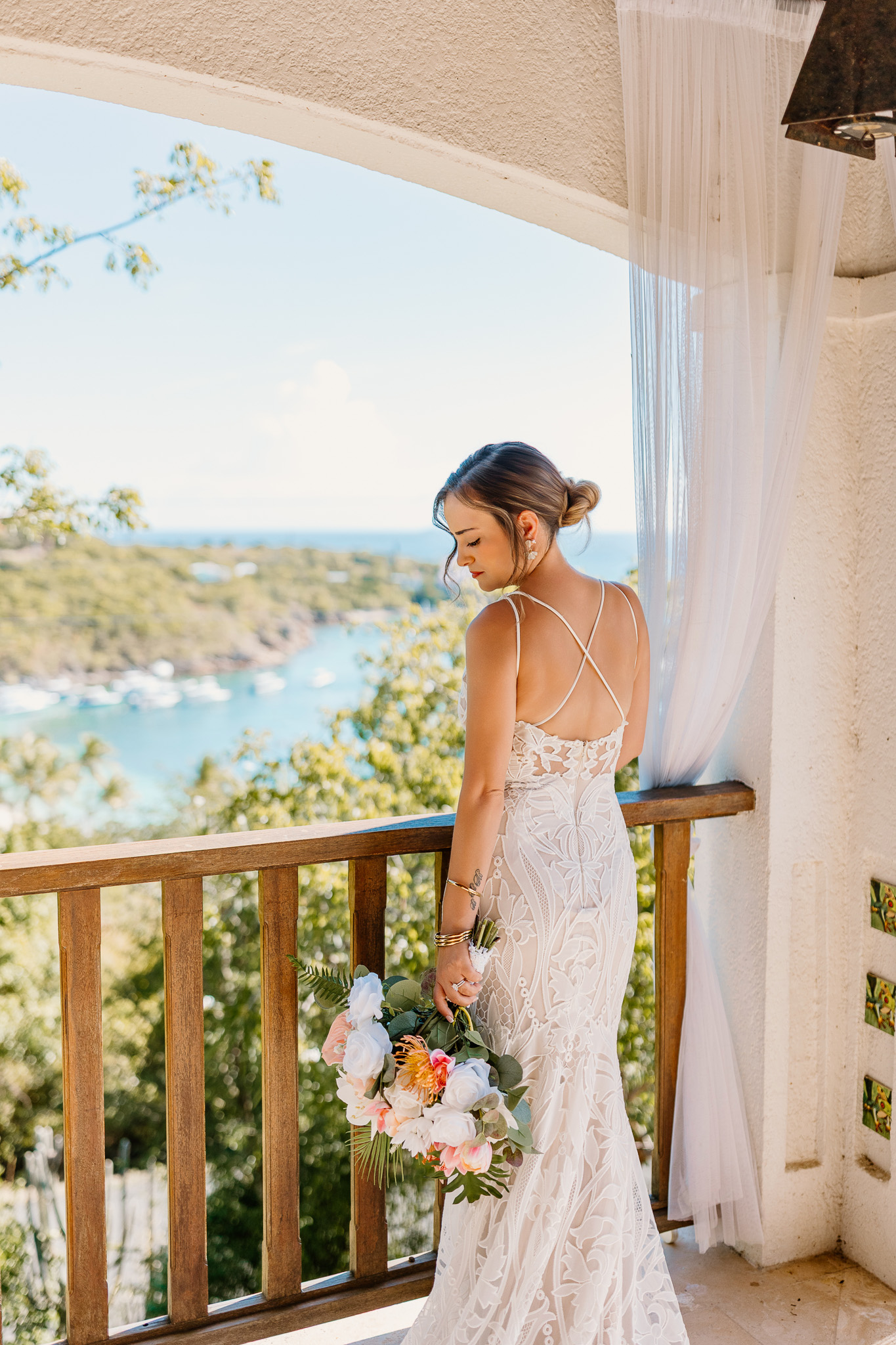 Bride and groom exchange vows during a beach wedding ceremony on Water Island, St. Thomas, USVI, surrounded by tropical ocean views.