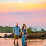 family splashing in the water during sunset at lake winnipesaukee