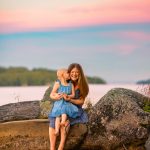 family splashing in the water during sunset at lake winnipesaukee
