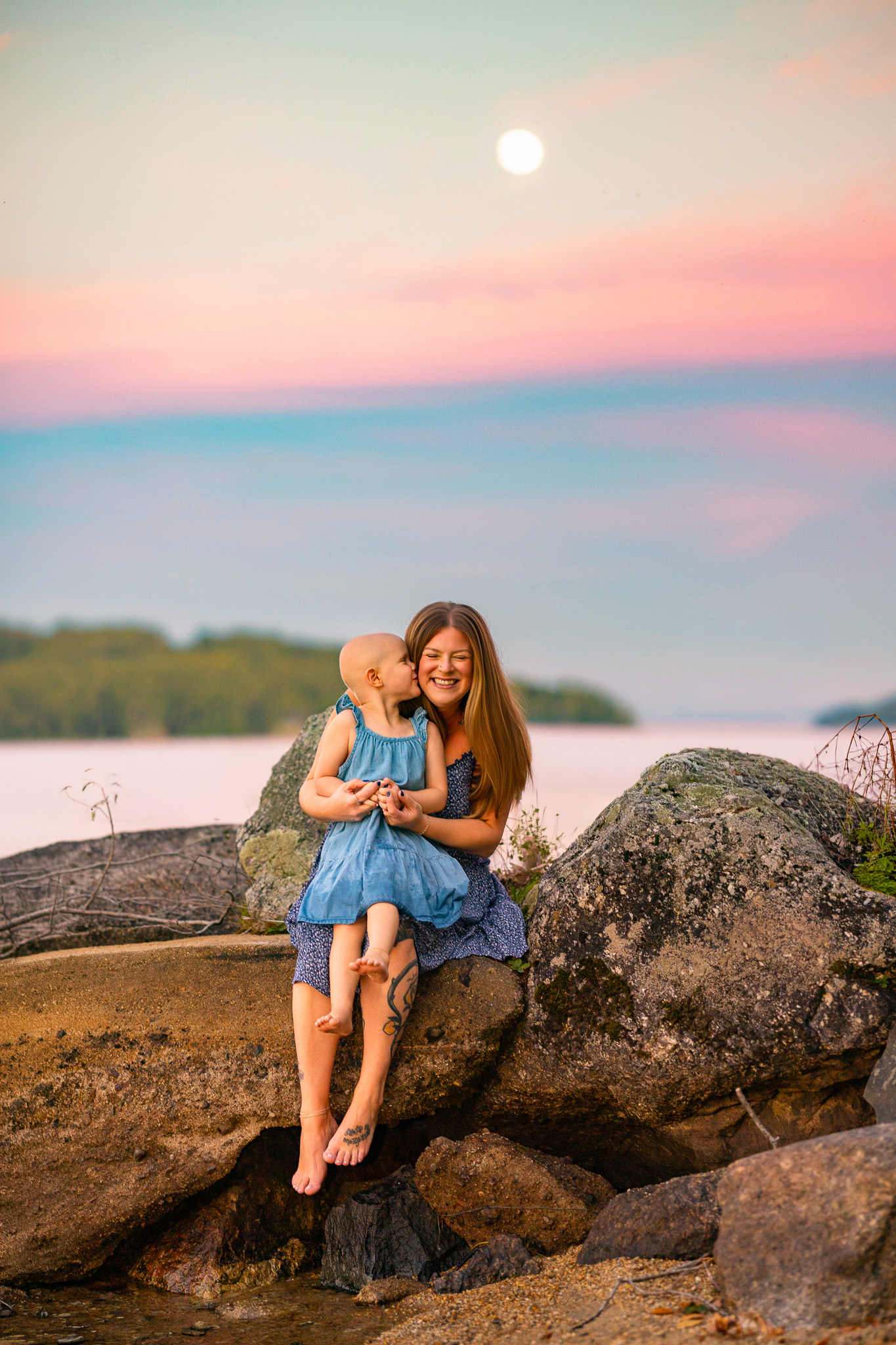 family splashing in the water during sunset at lake winnipesaukee