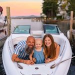 family splashing in the water during sunset at lake winnipesaukee