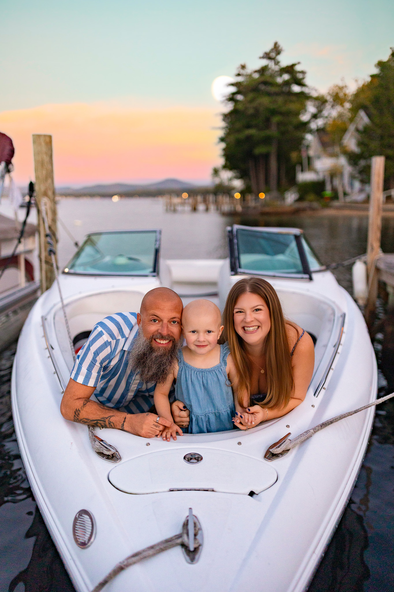 family splashing in the water during sunset at lake winnipesaukee