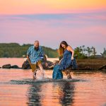 family splashing in the water during sunset at lake winnipesaukee